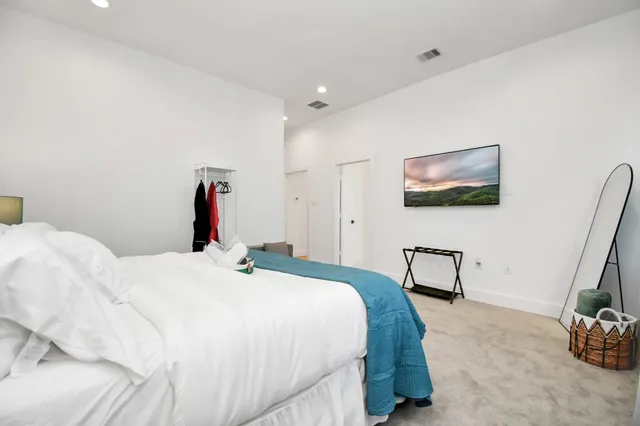 a bedroom with a bed and a dresser in it