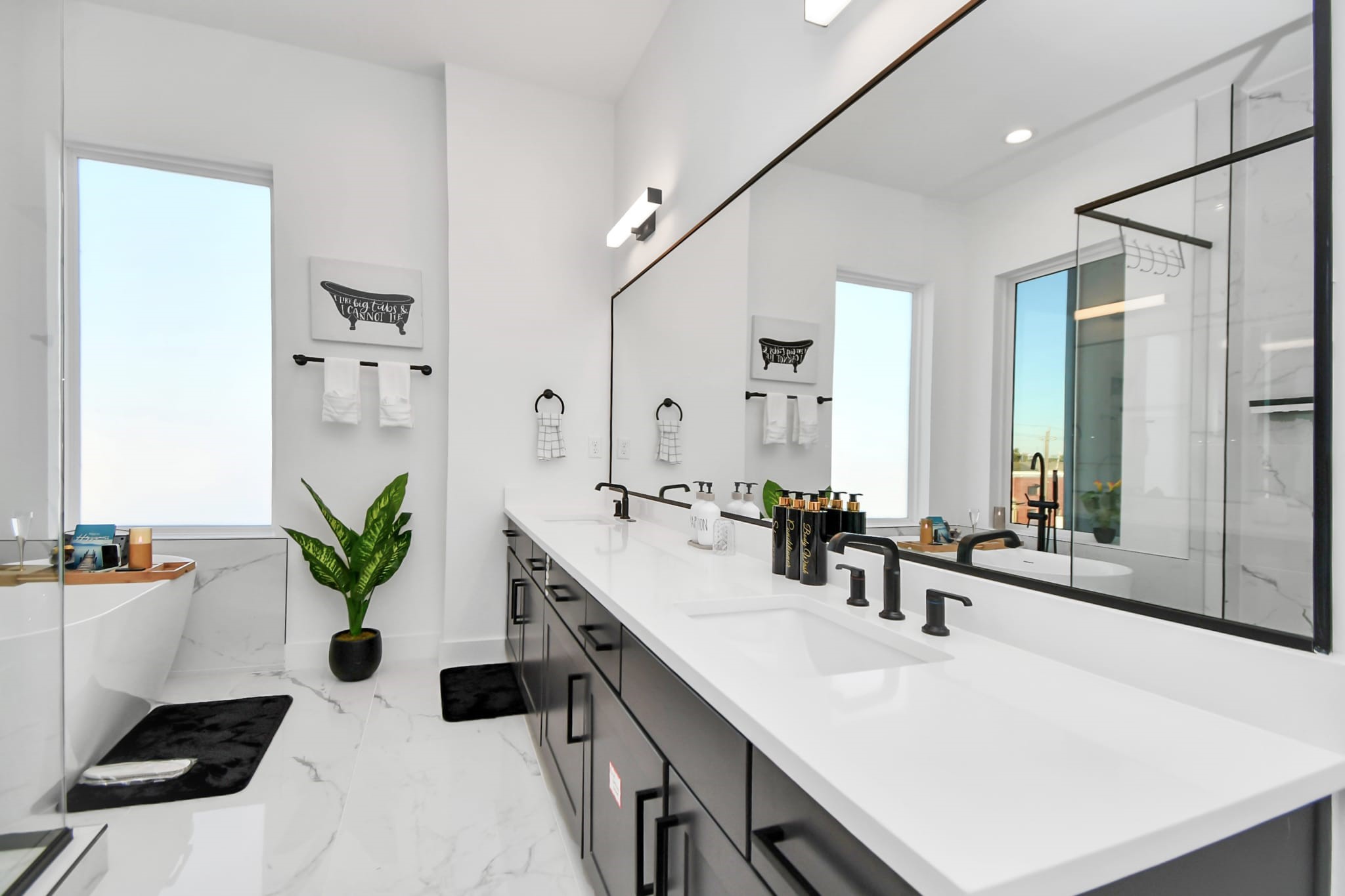 1104 Palmer Street Houston, TX 77003 - Photo 32 of 40 a bathroom with a double vanity sink a potted plant and a mirror