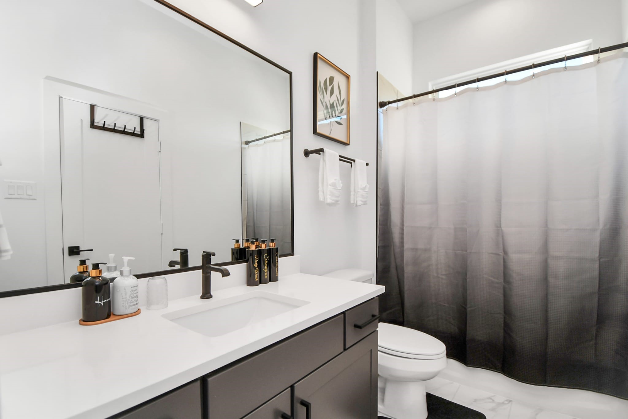 1104 Palmer Street Houston, TX 77003 - Photo 34 of 40 a bathroom with a sink a toilet a mirror and shower curtain