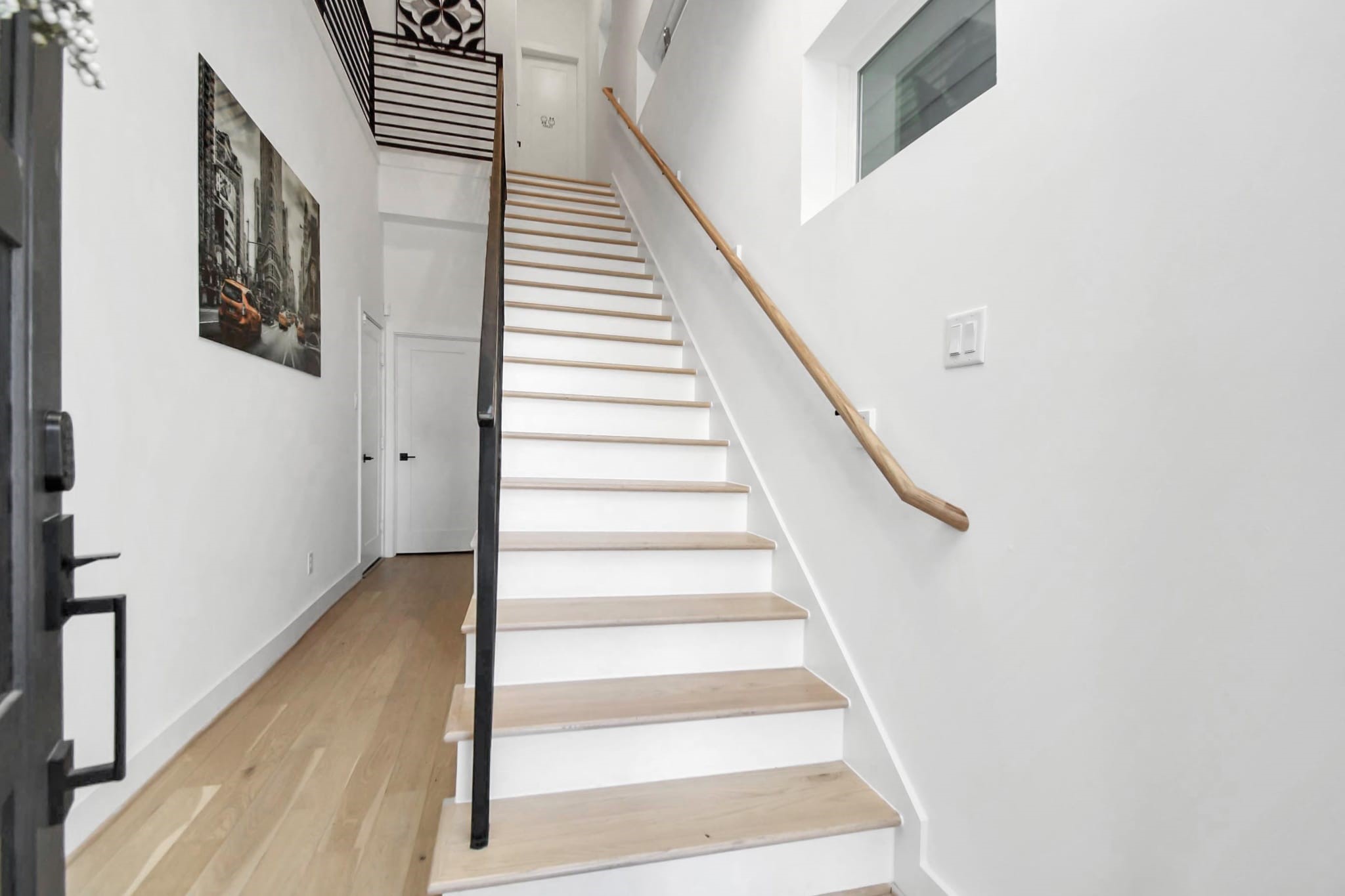 1104 Palmer Street Houston, TX 77003 - Photo 6 of 40 a view of staircase with wooden floor and white walls