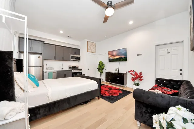 a bedroom with bed and a couch