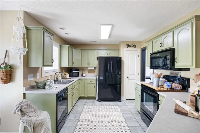 a kitchen with cabinets a sink and appliances