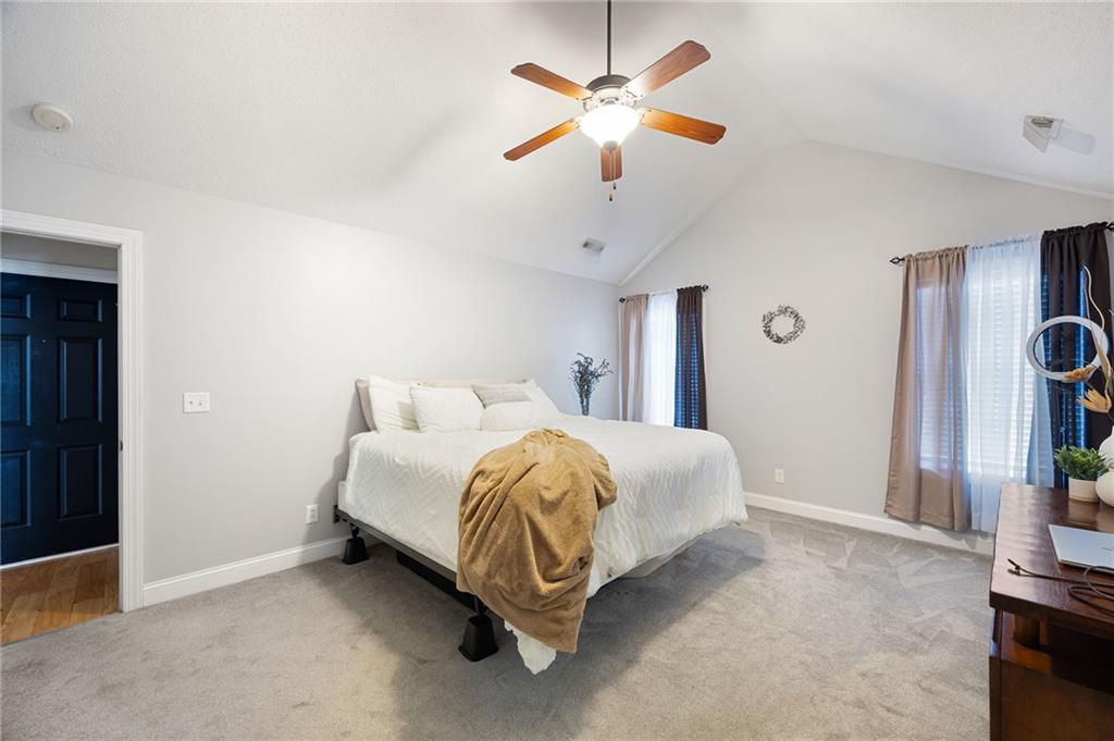 6 Keystone Lane Northeast Rome, GA 30161 - Photo 20 of 26 a spacious bedroom with a bed and a chandelier