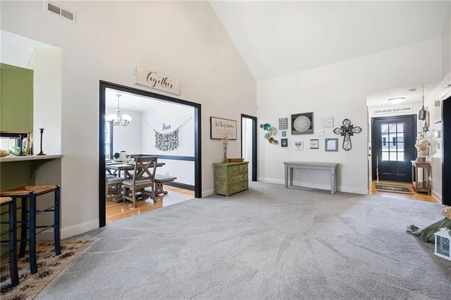 a view of a dining room with furniture and chandelier