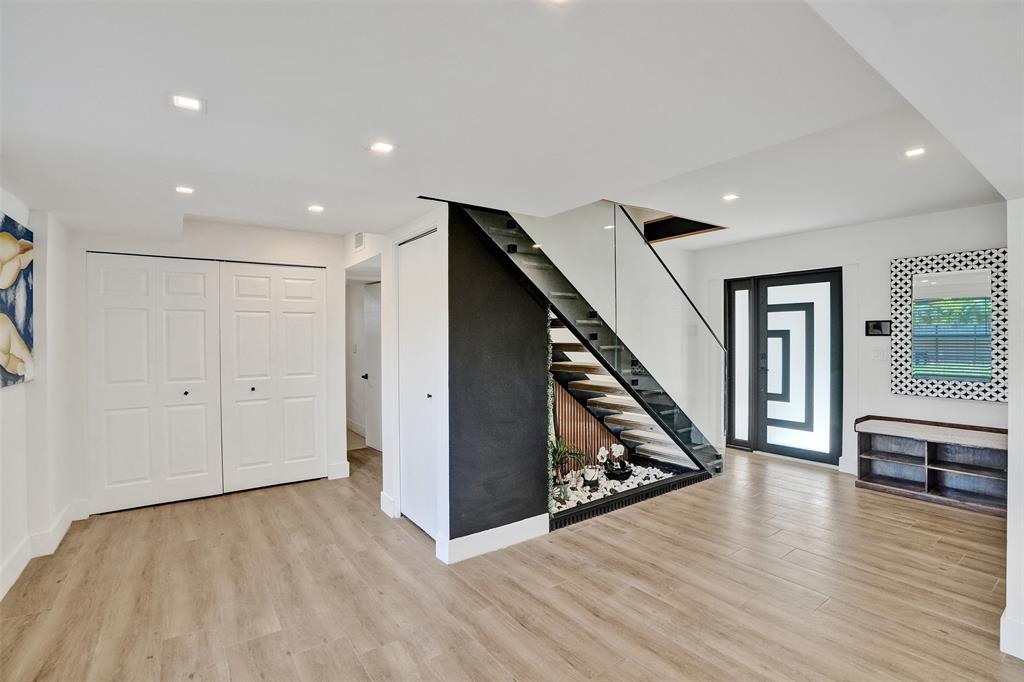 701 Northeast 164th Street Miami, FL 33162 - Photo 14 of 52 a view of an empty room with wooden floor and stairs