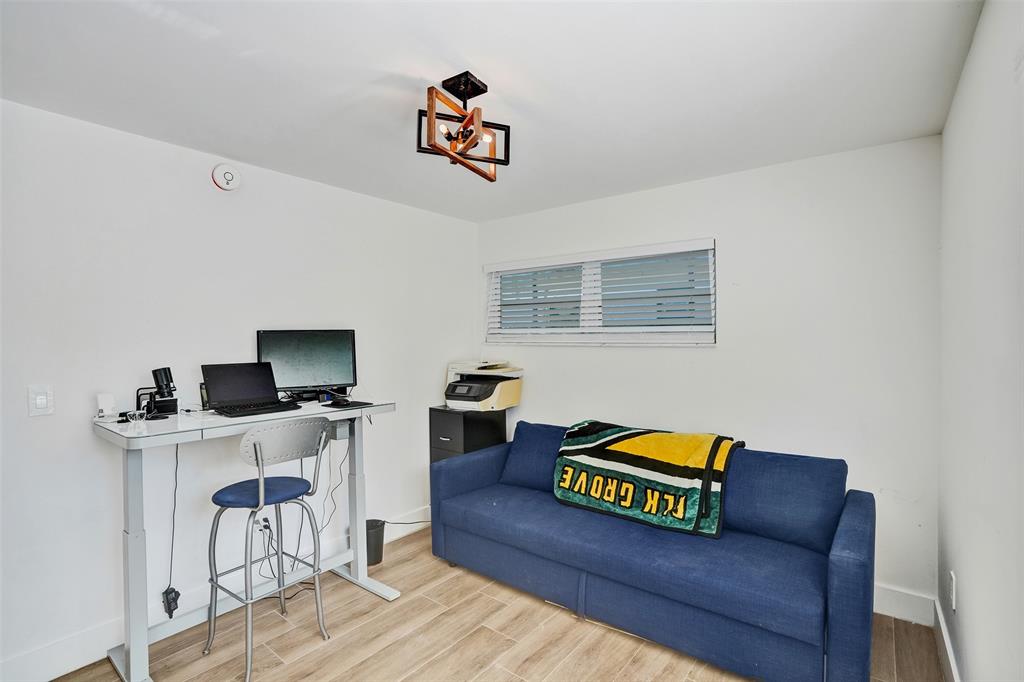 701 Northeast 164th Street Miami, FL 33162 - Photo 17 of 52 a living room with furniture and a flat screen tv
