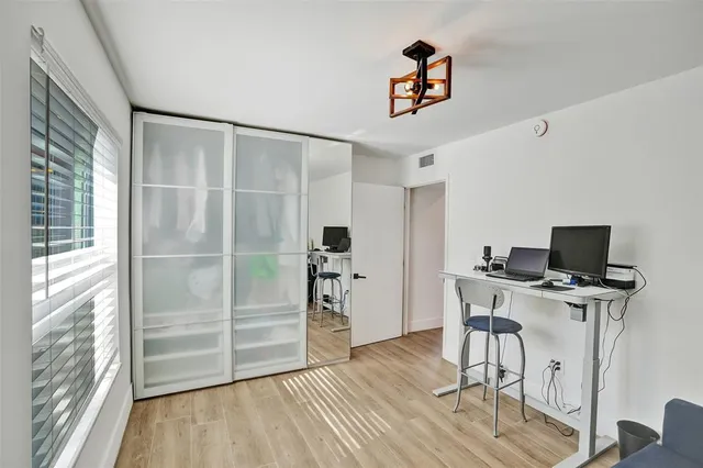 a view of a workspace with furniture and wooden floor