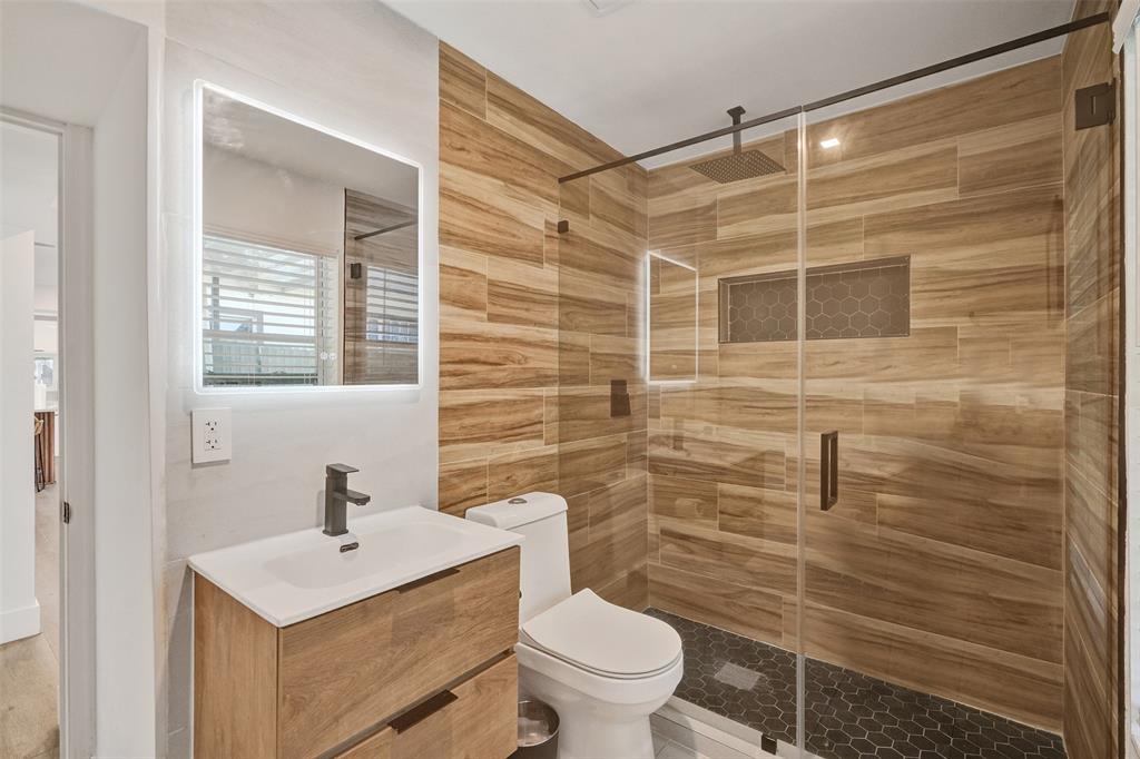 701 Northeast 164th Street Miami, FL 33162 - Photo 19 of 52 a bathroom with a shower toilet and sink