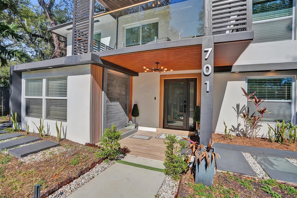 701 Northeast 164th Street Miami, FL 33162 - Photo 2 of 52 a front view of a house with garden