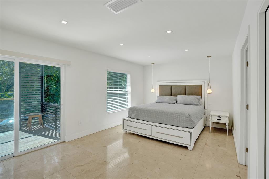 701 Northeast 164th Street Miami, FL 33162 - Photo 23 of 52 a bedroom with a bed and a window