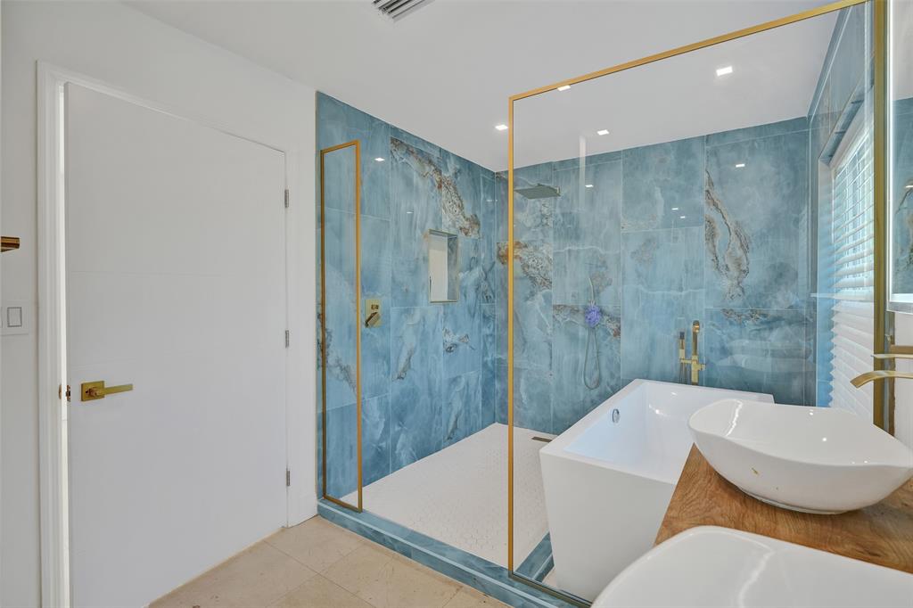 701 Northeast 164th Street Miami, FL 33162 - Photo 25 of 52 a bathroom with a sink and mirror with bathtub