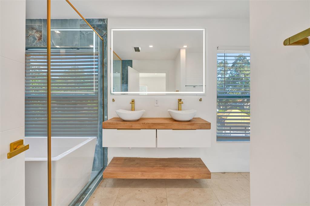 701 Northeast 164th Street Miami, FL 33162 - Photo 26 of 52 a view of a hallway with a dining table and chair