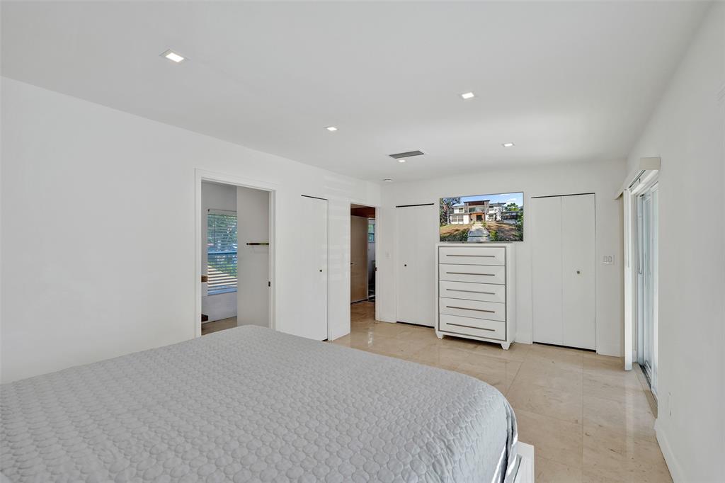 701 Northeast 164th Street Miami, FL 33162 - Photo 30 of 52 a bedroom with a bed and cabinets