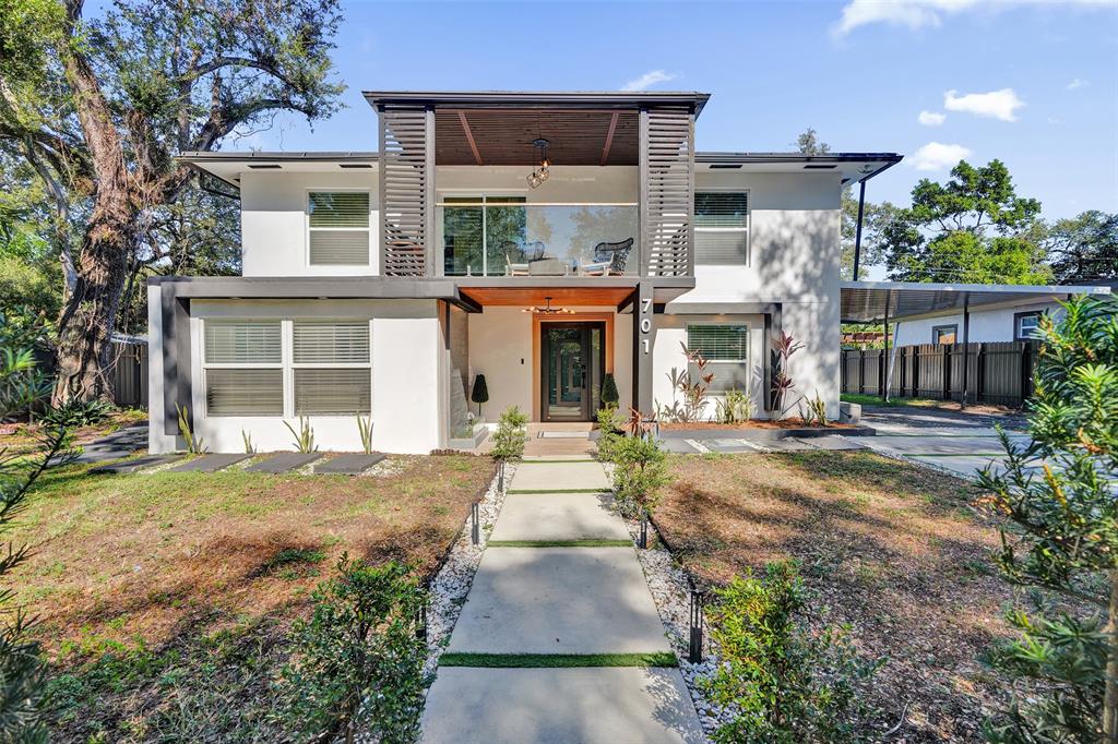 701 Northeast 164th Street Miami, FL 33162 - Photo 3 of 52 front view of a house with a yard