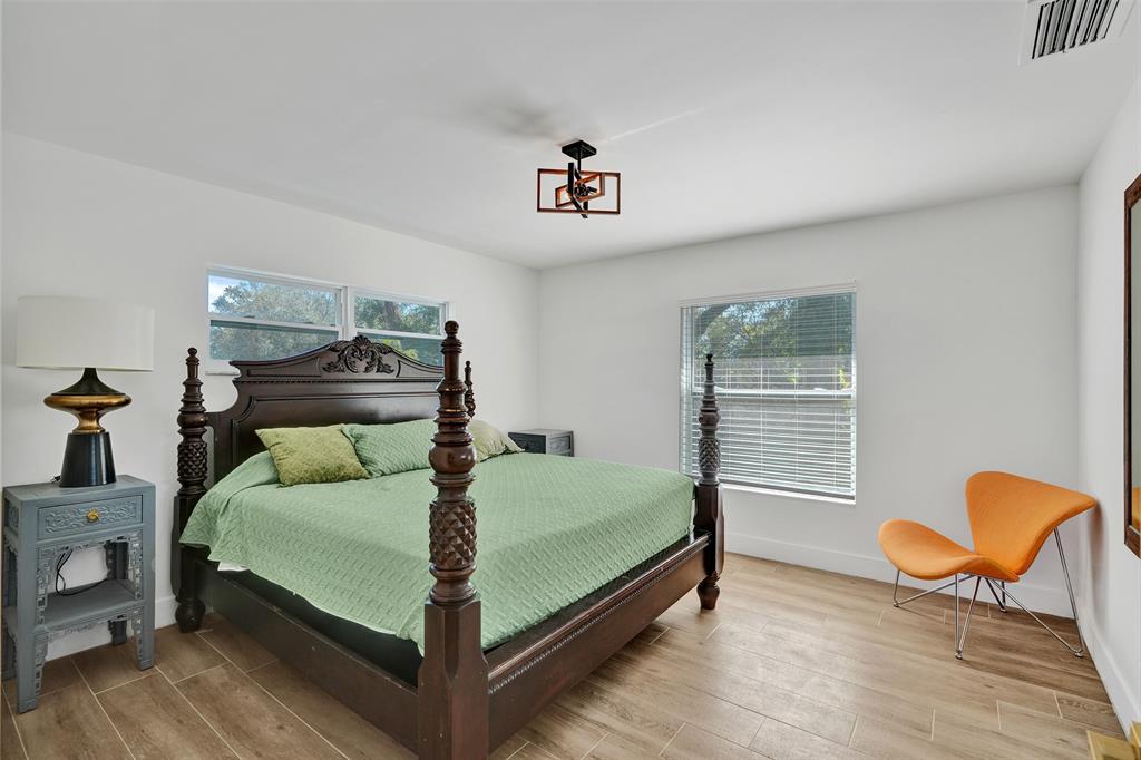 701 Northeast 164th Street Miami, FL 33162 - Photo 31 of 52 a bedroom with a bed and wooden floor