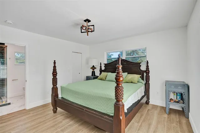 a bedroom with a bed and a chandelier