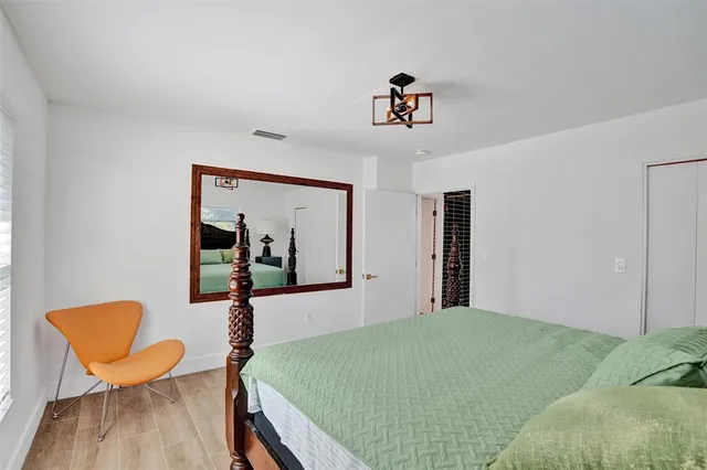 a bed room with a bed and chair