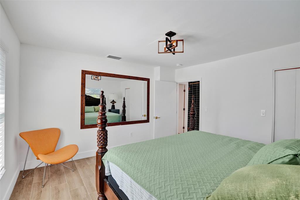 701 Northeast 164th Street Miami, FL 33162 - Photo 33 of 52 a bed room with a bed and chair