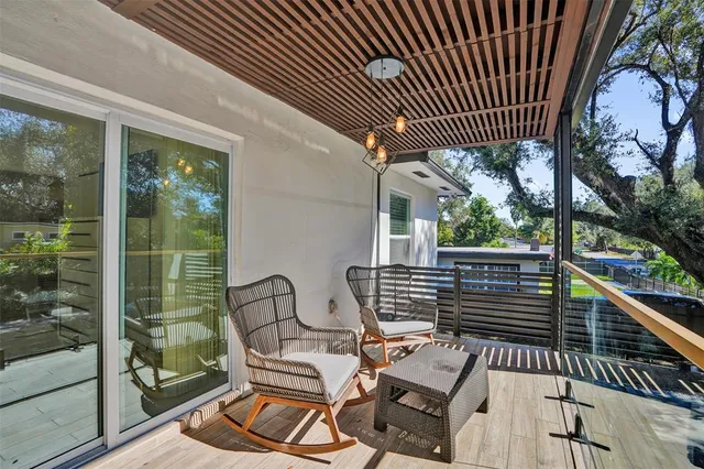 a view of a chairs and tables in the balcony