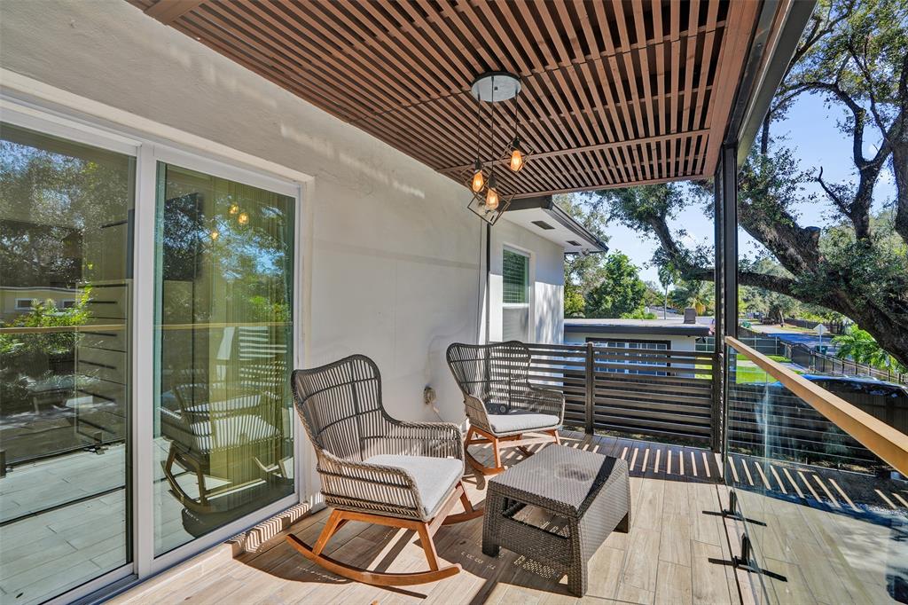 701 Northeast 164th Street Miami, FL 33162 - Photo 37 of 52 a view of a chairs and tables in the balcony