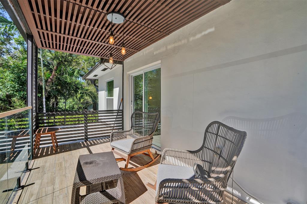 701 Northeast 164th Street Miami, FL 33162 - Photo 38 of 52 a patio with glass table and chairs