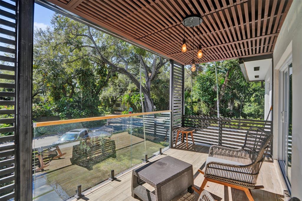 701 Northeast 164th Street Miami, FL 33162 - Photo 39 of 52 a view of a chairs and tables in the balcony