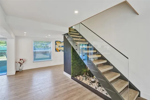 a view of entryway and hall with wooden floor