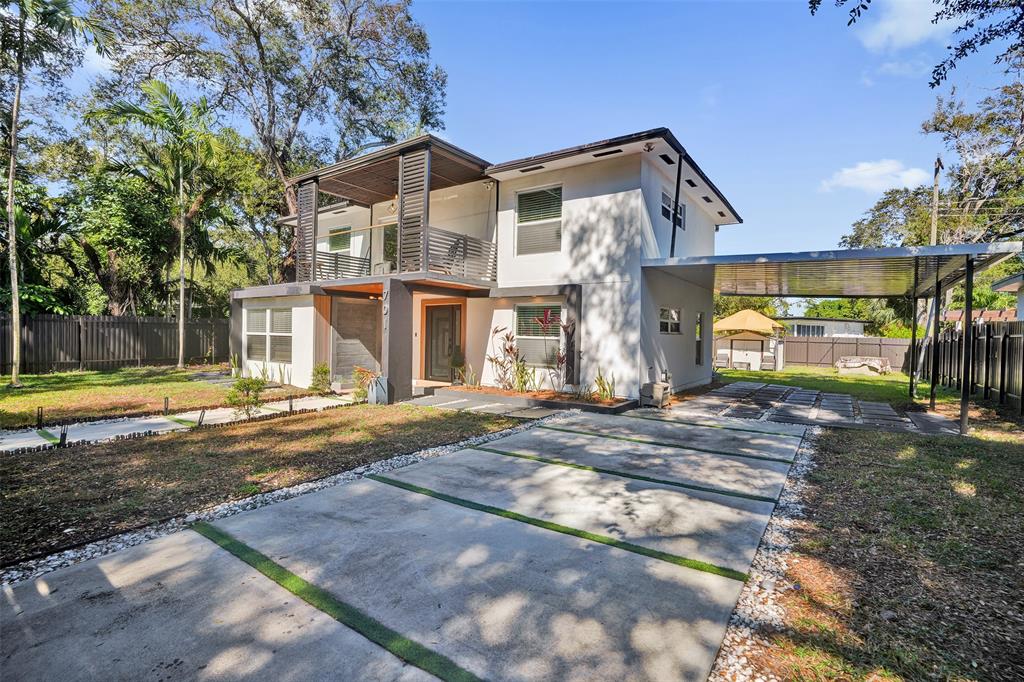 701 Northeast 164th Street Miami, FL 33162 - Photo 42 of 52 a view of a house with a yard and large tree