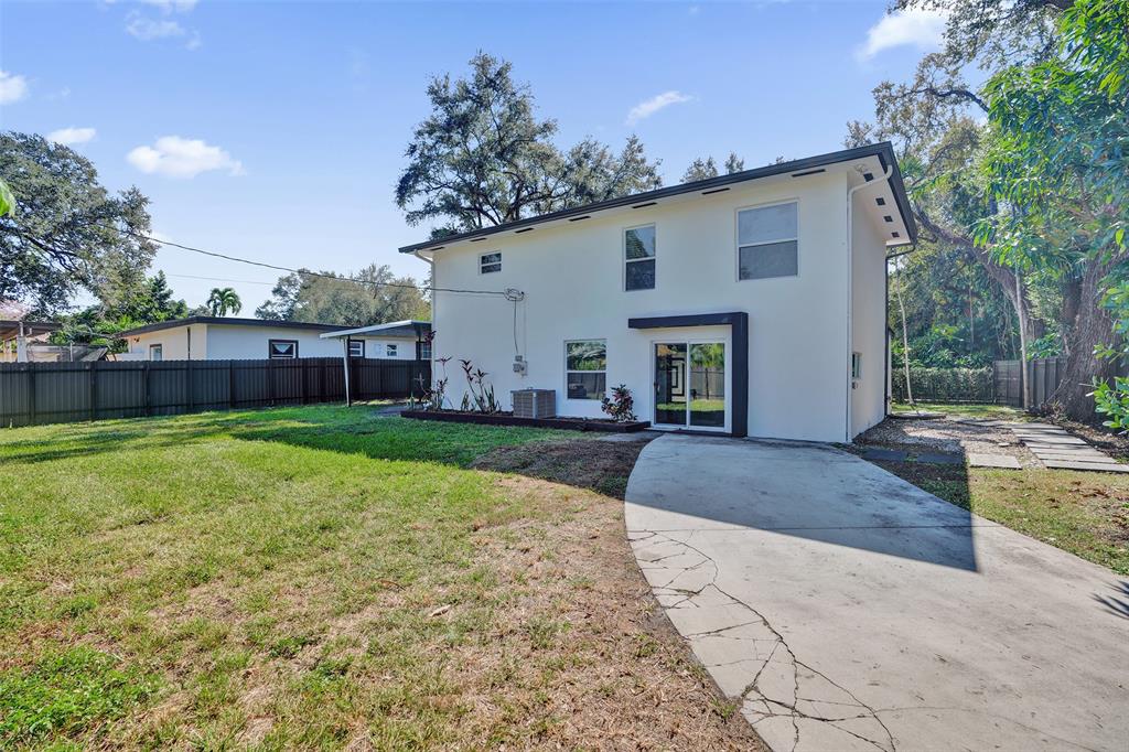 701 Northeast 164th Street Miami, FL 33162 - Photo 47 of 52 a view of a house with backyard and a tree