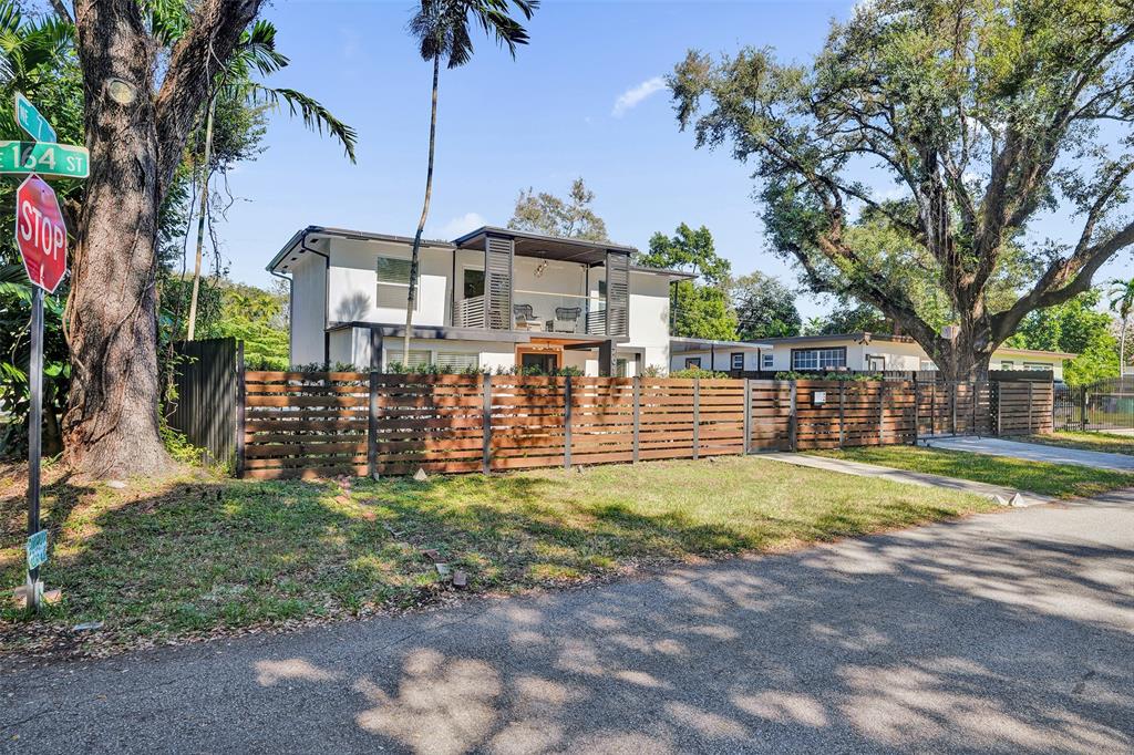 701 Northeast 164th Street Miami, FL 33162 - Photo 50 of 52 a front view of a house with a yard