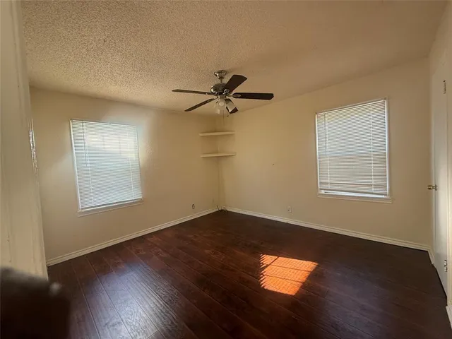 a view of a room with wooden floor and a window