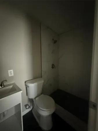 a bathroom with a toilet and a shower