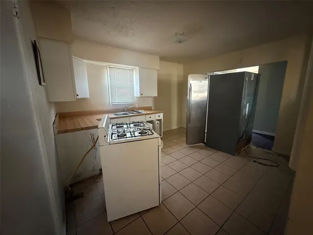 a kitchen with stainless steel appliances a refrigerator and a stove