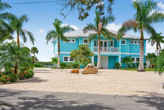 a view of a dining room with furniture a chandelier and wooden floor