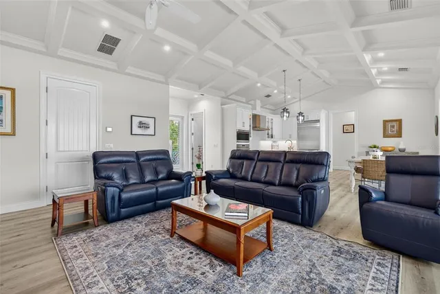 a bedroom with a large bed and a flat tv screen on dresser