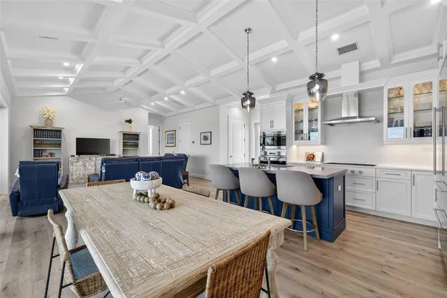 a bathroom with a granite countertop sink a potted plant and a wooden floor