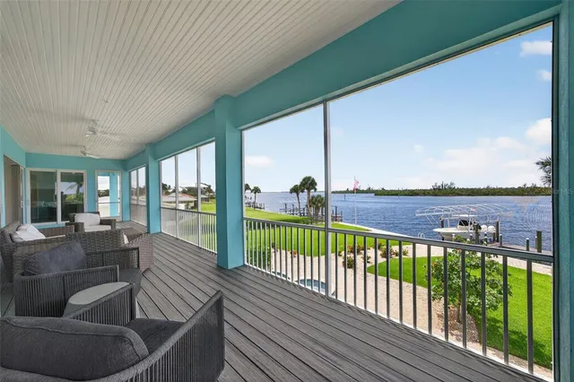 a view of a swimming pool with a table and chairs under an umbrella