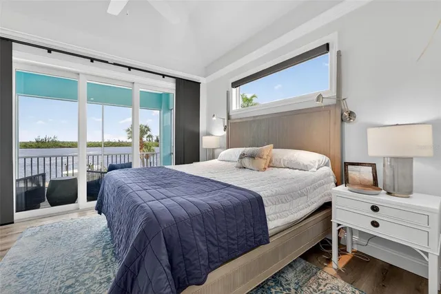an aerial view of ocean and residential houses with outdoor space