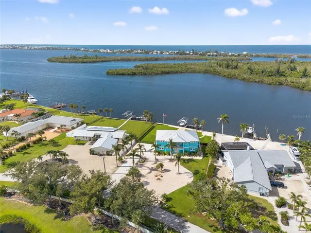 a living room with furniture a chandelier and a large window