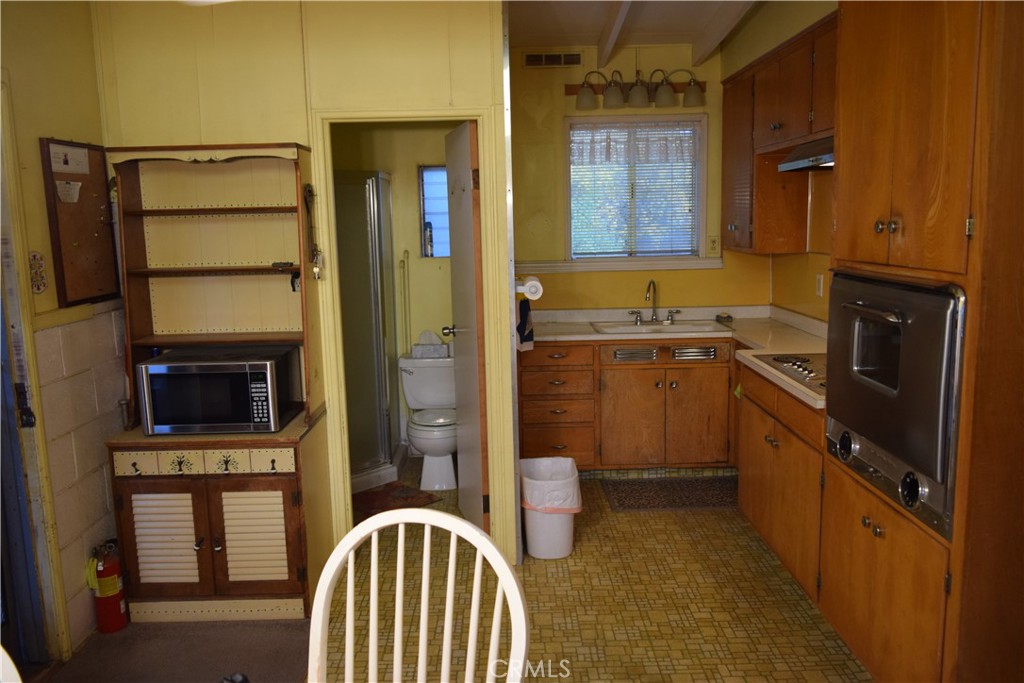 41329 Gibbel Road Hemet, CA 92544 - Photo 20 of 30 a kitchen with a sink a stove and cabinets