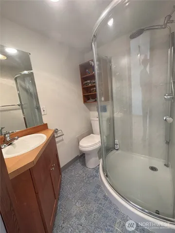 a bathroom with a sink a toilet and shower