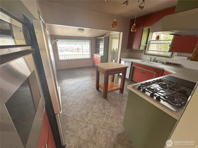 a kitchen with stainless steel appliances granite countertop a sink stove and a window