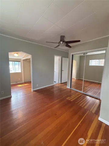 a view of empty room with wooden floor