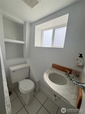 a white toilet sitting next to a bathroom sink