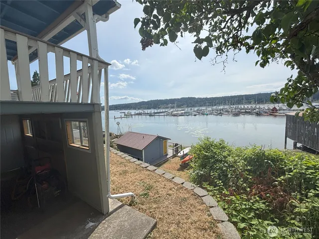 a front view of a house with lake view and a garden
