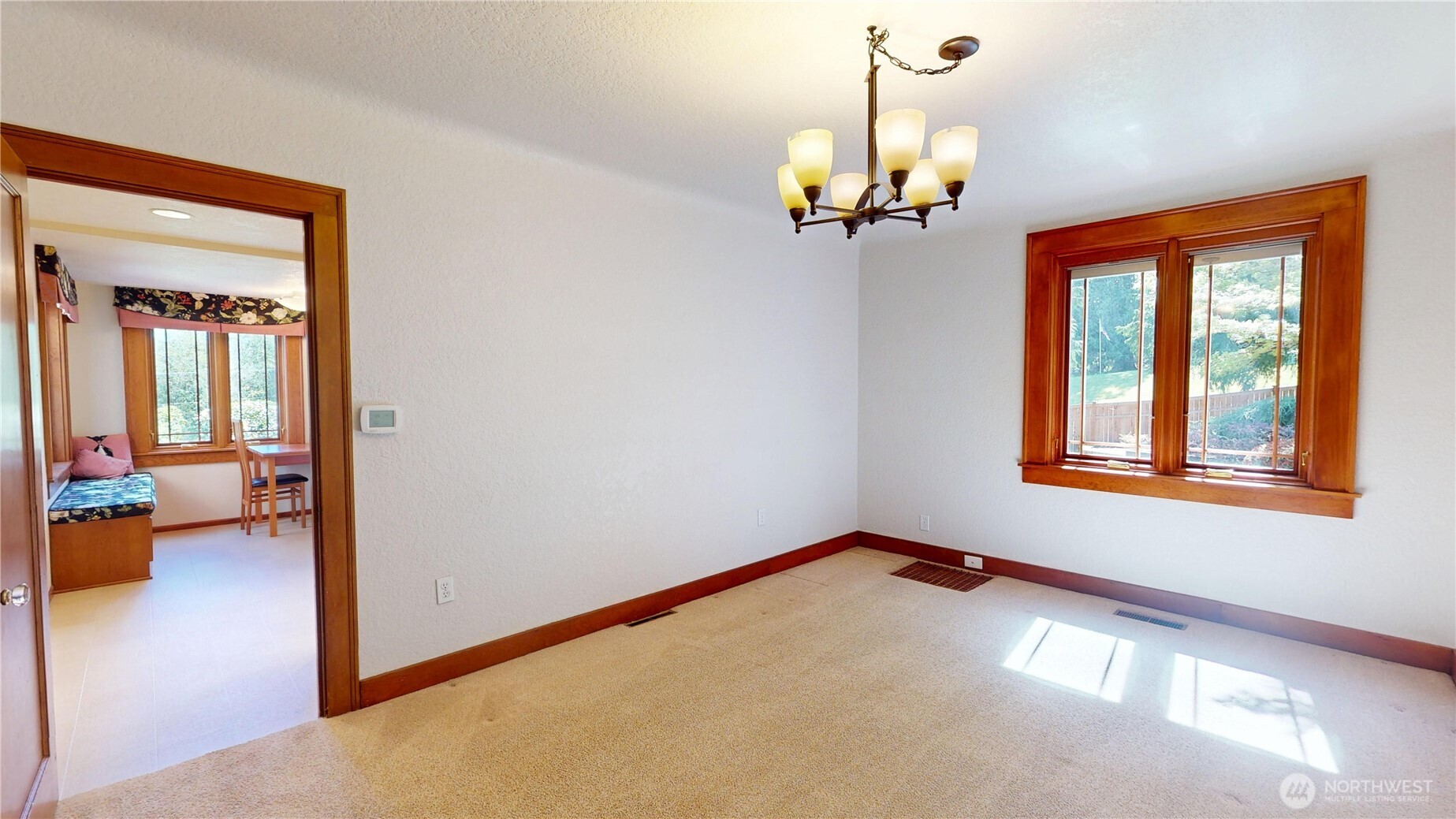 1533 Northeast Tagholm Road Poulsbo, WA 98370 - Photo 11 of 40 a view of a livingroom with a chandelier furniture and windows