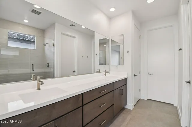 a bathroom with a double vanity sink mirror and