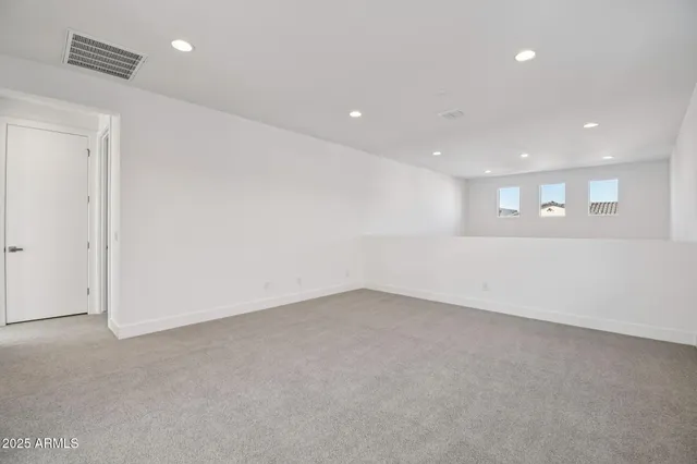 an empty room with a empty space and windows