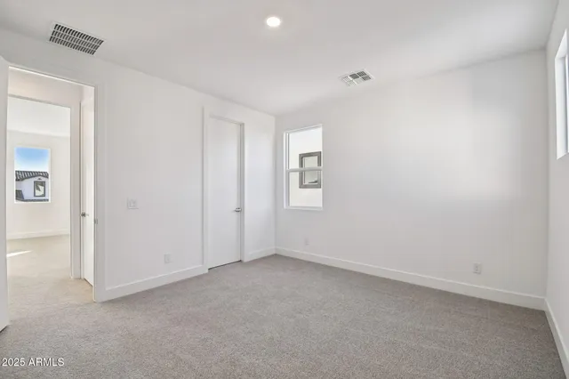 an empty room with windows and closet
