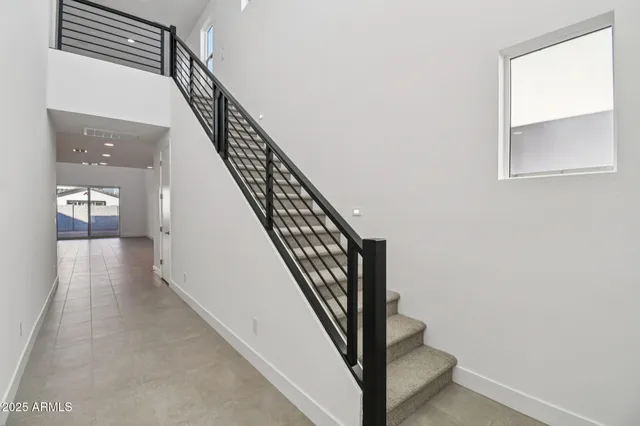 a view of staircase with white walls and a window